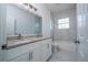 Bathroom featuring dual sinks, granite countertop, and marble tile at 1857 Manitoba Ct, Poinciana, FL 34759