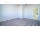 Clean and well-lit bedroom featuring neutral carpet and a view into the bathroom at 1857 Manitoba Ct, Poinciana, FL 34759