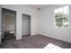 Cozy bedroom featuring plush gray carpeting, a window, and a closet with sliding doors at 1857 Manitoba Ct, Poinciana, FL 34759