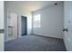 Bedroom with neutral carpet, closet, and bathroom access and window at 1857 Manitoba Ct, Poinciana, FL 34759