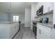 Well-lit kitchen features granite countertops and stainless steel appliances at 1857 Manitoba Ct, Poinciana, FL 34759