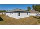 Rear view of the home with a well-maintained yard and classic architectural design at 1857 Manitoba Ct, Poinciana, FL 34759