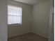 Bedroom featuring white walls, a window with blinds, and neutral carpeting at 1973 Portofino Meadows Blvd, Orlando, FL 32824