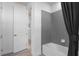 This bathroom features a hexagon tiled wall above the bathtub and a white door to the hallway at 2135 Weatherly Way, Orlando, FL 32820