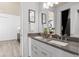 Modern bathroom with double sinks, gray countertops, and sleek fixtures at 2135 Weatherly Way, Orlando, FL 32820