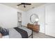 This bedroom features a black ceiling fan, a wooden dresser, and a gray bedspread at 2135 Weatherly Way, Orlando, FL 32820