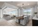 Bright dining room with a modern table, white chairs, and sliding glass doors to the outdoor living area at 2135 Weatherly Way, Orlando, FL 32820