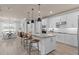 Bright kitchen featuring white cabinets, stainless steel appliances, pendant lighting, and a large center island at 2135 Weatherly Way, Orlando, FL 32820