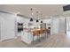 Well-lit kitchen boasting stainless steel appliances, a center island, and a view into the staircase at 2135 Weatherly Way, Orlando, FL 32820