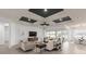 Bright, open living room with sliding glass doors, a coffered ceiling, and neutral furniture at 2135 Weatherly Way, Orlando, FL 32820