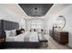 Spacious main bedroom featuring a decorative tray ceiling, sitting area, and wood-style tile floors at 2135 Weatherly Way, Orlando, FL 32820