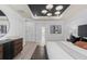 This is a main bedroom featuring a decorative tray ceiling, sitting area, and wood-style tile floors at 2135 Weatherly Way, Orlando, FL 32820