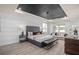 This is a main bedroom featuring a decorative tray ceiling, sitting area, and wood-style tile floors at 2135 Weatherly Way, Orlando, FL 32820