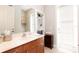 This bathroom offers a wood vanity, marble countertop, and a door to the backyard at 2161 Snow Rd, Orlando, FL 32814