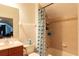 This bathroom features a shower/tub combo, a wood vanity, and tile flooring at 2161 Snow Rd, Orlando, FL 32814