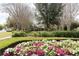 Manicured park featuring walkways, flower beds, trimmed bushes and views of playground at 2161 Snow Rd, Orlando, FL 32814