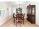 Traditional formal dining room showcasing wood floors, shuttered windows, and a chandelier at 2161 Snow Rd, Orlando, FL 32814