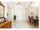 Bright foyer features tile flooring, a decorative tile medallion, and views into the dining room at 2161 Snow Rd, Orlando, FL 32814