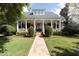 Charming two-story home with a welcoming front porch, beautiful landscaping, and a brick walkway at 2161 Snow Rd, Orlando, FL 32814