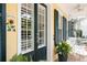 Inviting front porch with white columns, decorative shutters, and well-maintained landscaping at 2161 Snow Rd, Orlando, FL 32814