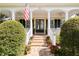 Inviting front porch with classic columns, brick steps, and charming landscaping enhances curb appeal at 2161 Snow Rd, Orlando, FL 32814