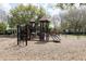 Community playground with climbing structures, slides, and swings on a mulch ground at 2161 Snow Rd, Orlando, FL 32814