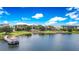 Scenic view of a lake with a gazebo, boardwalk, and nearby town center at 2161 Snow Rd, Orlando, FL 32814