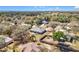 Aerial view of a beautiful home surrounded by lush greenery and a serene lake at 2253 Lake Pointe Cir, Leesburg, FL 34748