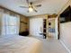 Bedroom features a ceiling fan, closet, and an open doorway to another room at 2253 Lake Pointe Cir, Leesburg, FL 34748