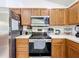 A view of the modern appliances and solid wood cabinets in the kitchen at 2253 Lake Pointe Cir, Leesburg, FL 34748