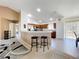 Open-concept kitchen and living area with breakfast bar and modern flooring at 2253 Lake Pointe Cir, Leesburg, FL 34748