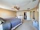 Comfortable main bedroom features a ceiling fan and large walk-in closet at 2253 Lake Pointe Cir, Leesburg, FL 34748