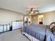 Airy bedroom with ensuite bathroom, ceiling fan, and light-colored walls with plenty of natural light at 2253 Lake Pointe Cir, Leesburg, FL 34748