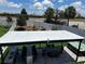 Aerial view of the backyard featuring outdoor kitchen, dining space, landscaped yard, and perimeter privacy fence at 2403 Biscotto Cir, Davenport, FL 33897