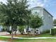 A two-story home boasts lovely landscaping, including mature trees and bushes at 2403 Biscotto Cir, Davenport, FL 33897