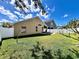 Beautiful backyard view showing a lush green lawn and brick paver patio, complete with a white picket fence at 2707 Barnsley Ln, Kissimmee, FL 34744