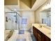 Bright bathroom with dual vanity, soaking tub, and glass shower at 2707 Barnsley Ln, Kissimmee, FL 34744