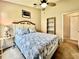 Comfortable bedroom with a queen-sized bed, ceiling fan and a view of the backyard at 2707 Barnsley Ln, Kissimmee, FL 34744