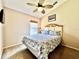 Bedroom with a ceiling fan, carpeted floor, window, and a queen size bed at 2707 Barnsley Ln, Kissimmee, FL 34744