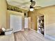 Bedroom featuring hardwood floors, trophy shelving, and a ceiling fan at 2707 Barnsley Ln, Kissimmee, FL 34744