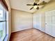 Cozy empty bedroom with hardwood floors, a ceiling fan, and a double door closet at 2707 Barnsley Ln, Kissimmee, FL 34744