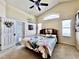 Well-lit bedroom boasts vaulted ceiling, fan, multiple windows, and exterior access at 2707 Barnsley Ln, Kissimmee, FL 34744