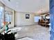 Sunlit dining room featuring a modern chandelier, large windows, and plush carpeting at 2707 Barnsley Ln, Kissimmee, FL 34744