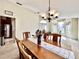 Traditional dining room with ample natural light, elegant chandelier, and neutral decor for a welcoming ambiance at 2707 Barnsley Ln, Kissimmee, FL 34744