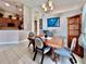 This dining room features tile floors, neutral walls, and a wood table with blue padded chairs at 2707 Barnsley Ln, Kissimmee, FL 34744