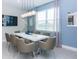 A dining room featuring a white table with seating for eight, chandelier and light blue walls at 288 Auburn Ave, Kissimmee, FL 34747