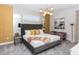 A bedroom with a king bed, mirrored accent wall, art and stylish lighting fixture at 288 Auburn Ave, Kissimmee, FL 34747