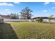 Expansive backyard showcasing well-maintained lawn, white fencing, and mature trees at 288 Garland, Deltona, FL 32725