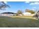 Spacious backyard featuring a white fence, a swing set, and lush green grass at 288 Garland, Deltona, FL 32725