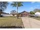 Inviting single-Gathering home featuring a spacious driveway and lush front yard at 288 Garland, Deltona, FL 32725